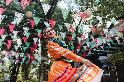 Latin woman dancer wearing traditional Mexican dress traditional from Guadalajara Jalisco Mexico Latin America, young hispanic female in independence day or cinco de mayo parade or cultural Festival