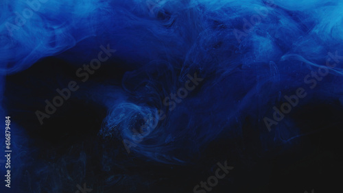 Ink water swirl. Color smoke cloud. Night haze. Blue fume cloud explosion wave texture on dark black abstract art background.