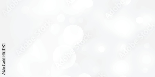 Abstract silver bokeh background with white light at center. The bokeh on the white background blurred the natural gray and white. Bokeh colorful glows sparkle.