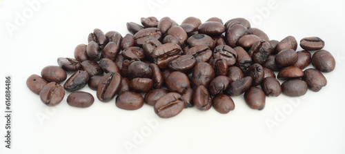 Pile of Dark brown roasted coffee beans isolated on white background, Raw processed food for drinks refreshment