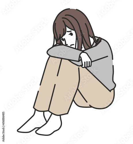 落ち込む体育座りの女性