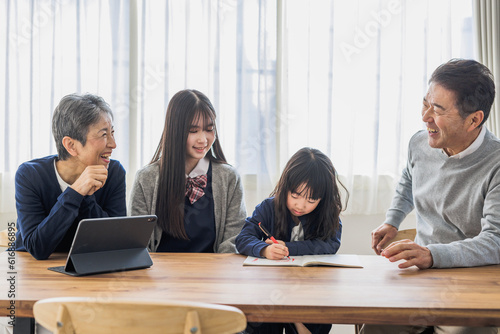 勉強する孫を見守る日本人シニア夫婦 photo
