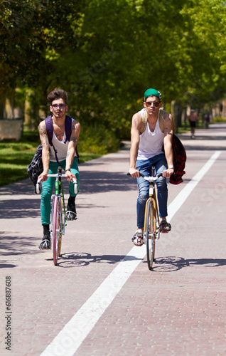 Bicycle, travel and men friends in a city street riding, bond and enjoying freedom on holiday or vacation together. Cycling, bike and people in a road with freedom, adventure and neighborhood hangout