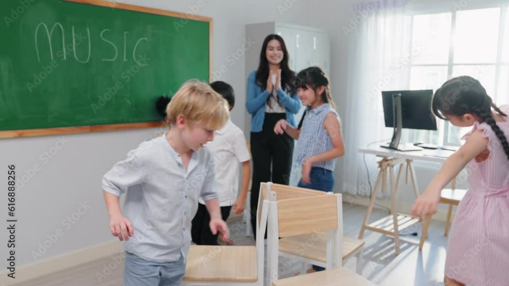 Group of adorable school kids playing active games with teacher in classroom on summer at elementary school. independent and relax activities concept Group of adorable school kids playing active games with teacher in classroom on summer at elementary school. independent and relax activities concept