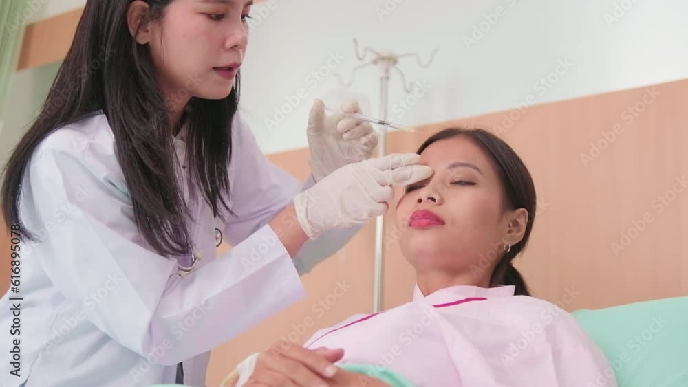 Asian female cosmetic doctor inject Botox into face of woman patient, face care, skin treatment, and young aging with body skincare at beauty clinic hospital, and cosmology medical. Asian female cosmetic doctor inject Botox into face of woman patient, face care, skin treatment, and young aging with body skincare at beauty clinic hospital, and cosmology medical.