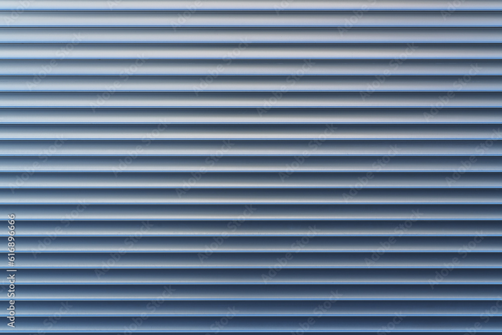 Texture and pattern of exterior roller aluminum shutters on a large shopwindow as background Texture and pattern of exterior roller aluminum shutters on a large shopwindow as background