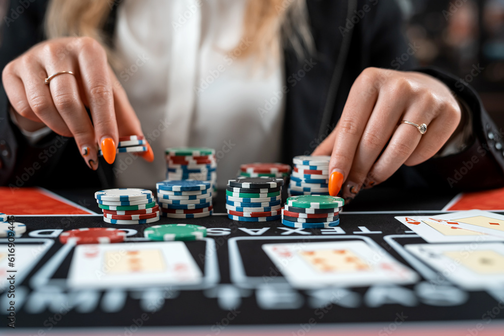 Pretty woman playing poker makes a bet with chips all in Pretty woman playing poker makes a bet with chips all in