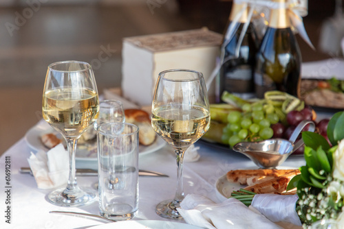 Close up of glasses of wine and snacks on the table