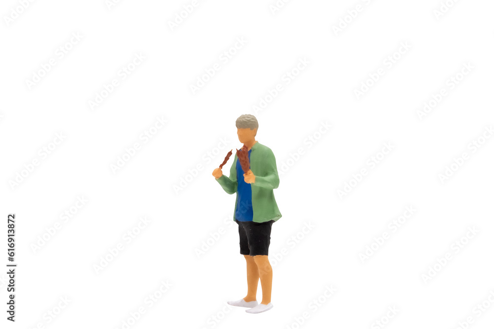 Miniature people Young man grilling BBQ isolated on white background with clipping path Miniature people Young man grilling BBQ isolated on white background with clipping path