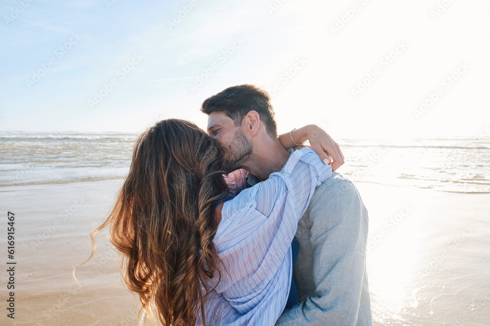 Romantic couple embracing and kissing at beach Romantic couple embracing and kissing at beach
