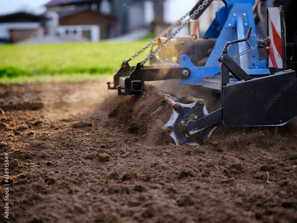 Farmer using tractor and plowing soil in field Farmer using tractor and plowing soil in field