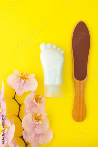 Tube-container for cosmetic foot cream. Concept of natural cosmetics and skin care. Set of pedicure tools. Studio shot with copy space, empty, unfilled. Vertical photo