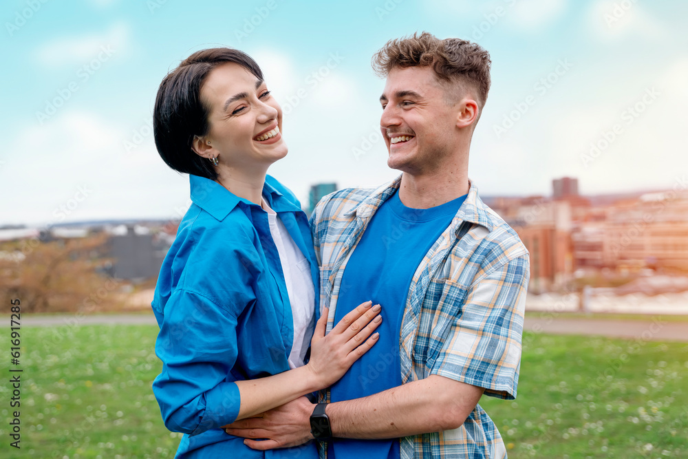 Fototapeta premium a young woman and a man met and hugged in the park on a walk