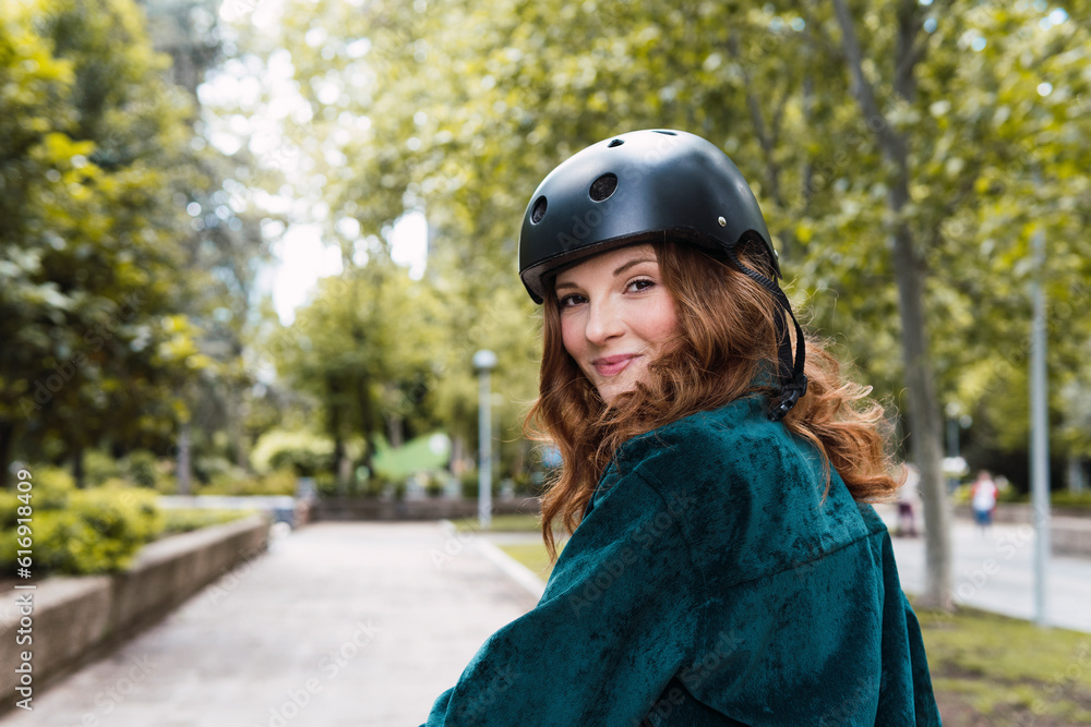 Smiling young woman wearing helmet in park Smiling young woman wearing helmet in park