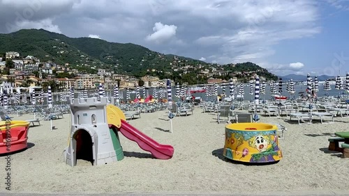 Beach Flora and Lido, Rapallo in Italy, sandy beach with children's playground, sun loungers, sunbrellas etc. photo