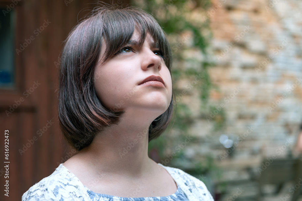 Sad teen girl on a summer street. Close-up portrait of beautiful teen girl on the street. Sad teen girl on a summer street. Close-up portrait of beautiful teen girl on the street.