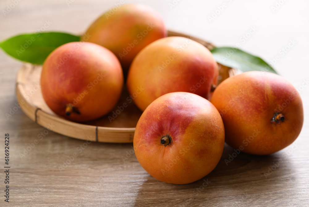 Mango fruit (Tommy Atkins) on wooden background, Tropical fruit Mango fruit (Tommy Atkins) on wooden background, Tropical fruit
