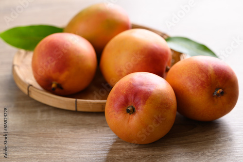 Fototapeta Naklejka Na Ścianę i Meble -  Mango fruit (Tommy Atkins) on wooden background, Tropical fruit