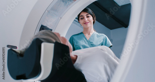 Quadro su tela Female finished magnetic resonance imaging, Patient is moving out of MRI scanner capsule