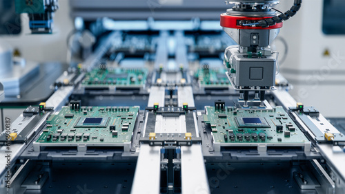 Component Installation on Circuit Board. Fully Automated Modern PCB Assembly Line Equipped with Advanced High Precision Robot Arms at Bright Electronics Factory. Electronic Devices Production Industry