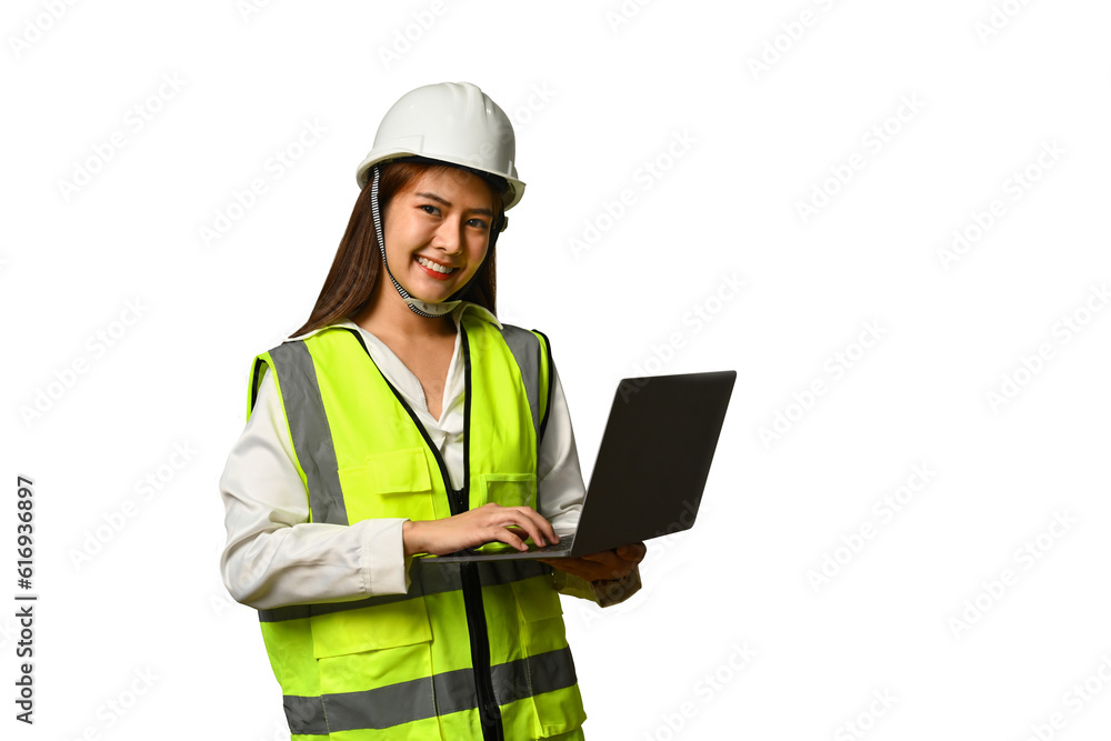 Smiling civil engineer woman wearing helmet and vest holding laptop isolated white background Smiling civil engineer woman wearing helmet and vest holding laptop isolated white background
