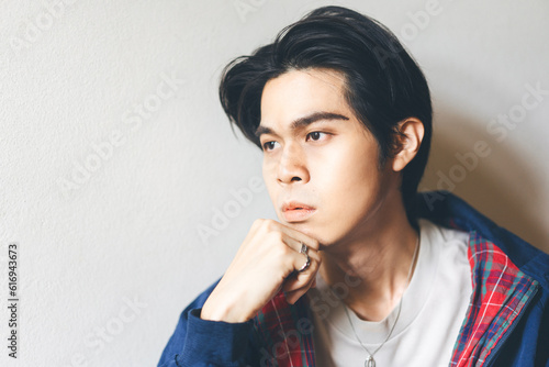 Head shot portrait of young adult asian man with a fashion retro jacket and black short hair
