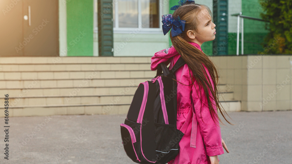 first day of school. student girl primary school is upset and does not want to go to class. The first day of autumn. concept back to school.