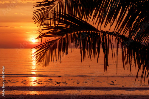 A beautiful tropical beach in golden colors at sunset. For traveling and relaxing during the vacation relax time.