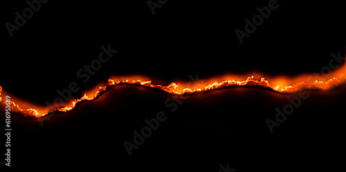 burning paper, glowing edge of paper on a black background photo