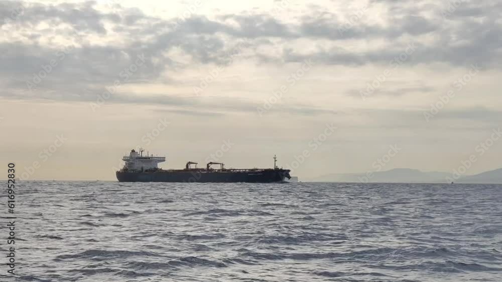 An unidentified empty cargo ship headed back to the port, sailing in the waters of Strait of Gibraltar An unidentified empty cargo ship headed back to the port, sailing in the waters of Strait of Gibraltar