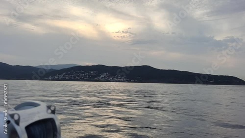 Jebel Musa Mountain is seen from a distance from boat swimming in the water of Gibraltar. Jebel Musa is a mountain in the northernmost part of Morocco, on the African side of the Strait of Gibraltar. photo