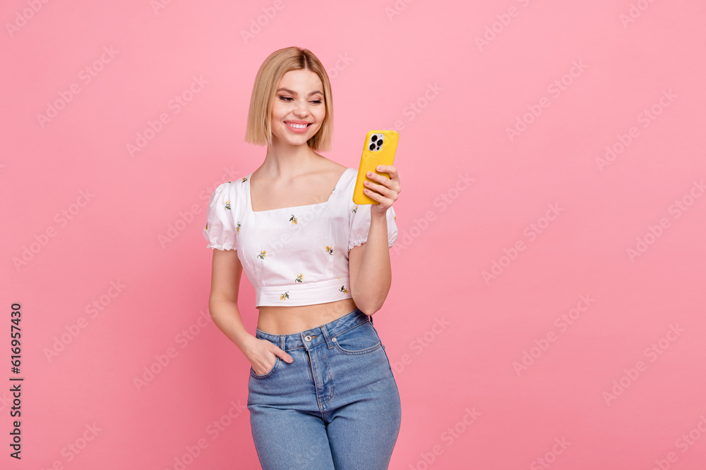 Photo of funny young lady blonde hair wear white trendy blouse hold gadget typing fast order pizza online isolated on pink color background Photo of funny young lady blonde hair wear white trendy blouse hold gadget typing fast order pizza online isolated on pink color background