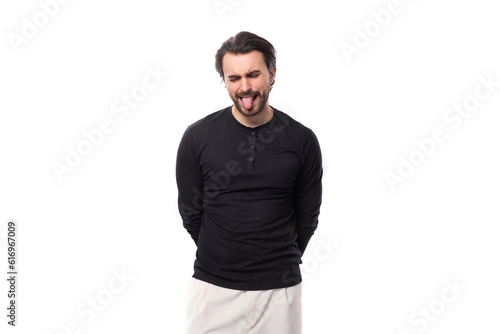 close-up portrait of a young 30 years old bearded well-groomed brunette with a chic stylish hairstyle in a black sweater with a mockup for identity and branding