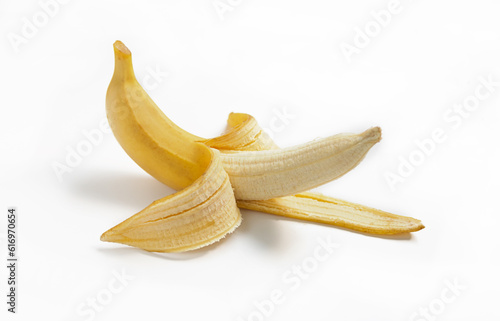 Half peeled ripe banana with peel on a white isolated background