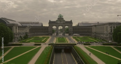 Establishing shot city of Brussels, Belgium. The Cinquantenaire memorial arch at the Parc du Cinquantenaire. Busy road, highway in the middle of the park. Traffic movement photo