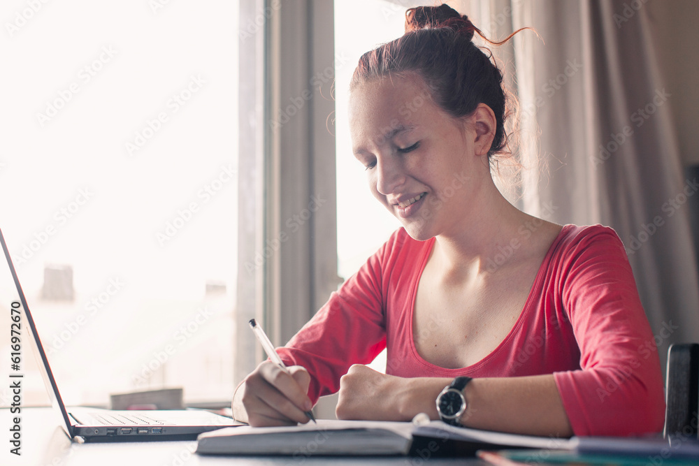 Obraz premium Millennial student sit at desk study on laptop