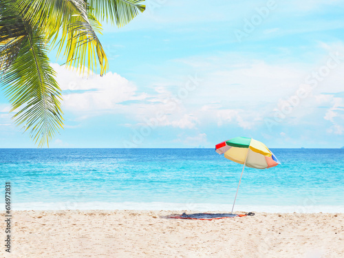 Fototapeta Naklejka Na Ścianę i Meble -  Colorful umbrella  on sand over blue sky and sea landscape.