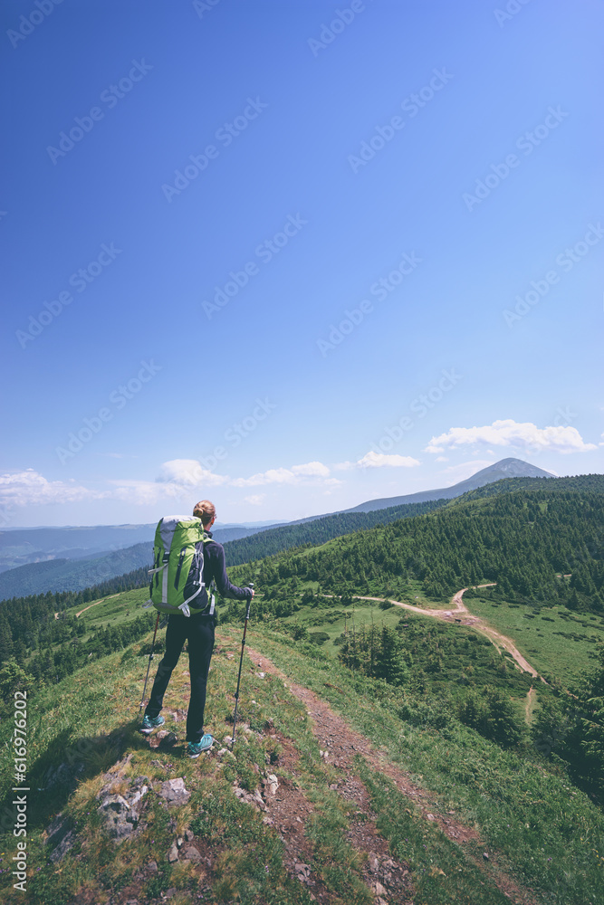 Active lifestyle. Traveling, hiking and trekking concept. Young woman with backpack in the Carpathian mountains.