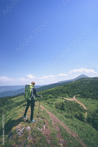 Active lifestyle. Traveling, hiking and trekking concept. Young woman with backpack in the Carpathian mountains. © luengo_ua