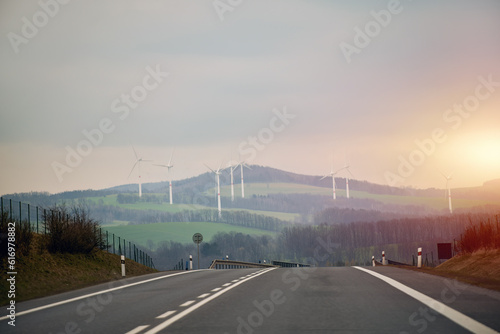 Harvesting Green Energy. Wind Turbines Amidst a Summer landscape. Renewable Energy Generation. Aerial View of Wind Turbines