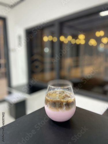 Strawberry milk coffee in a glass inside the cafe