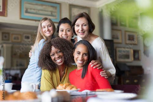 Portrait smiling women friends dining at restaurant table