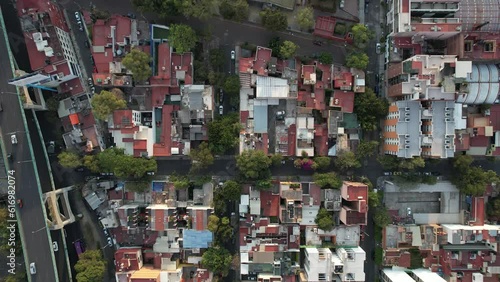 orbital shot of Aztec pyramid of mixcoac in the middle of a neighborhood in Mexico city photo