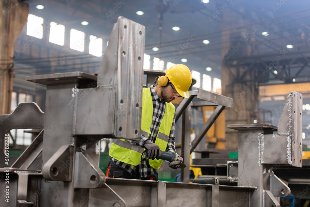 Steel worker working in fabrication factory Steel worker working in fabrication factory