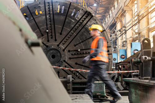 Steel worker walking in factory