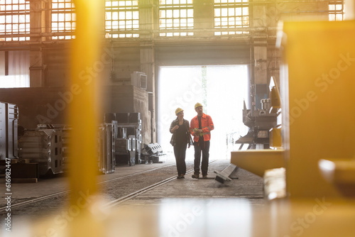 Steel workers walking in factory