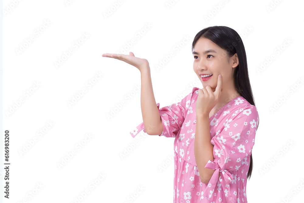 Asian beautiful young woman with black long hair in pink shirt shows present something isolated on white background. Asian beautiful young woman with black long hair in pink shirt shows present something isolated on white background.