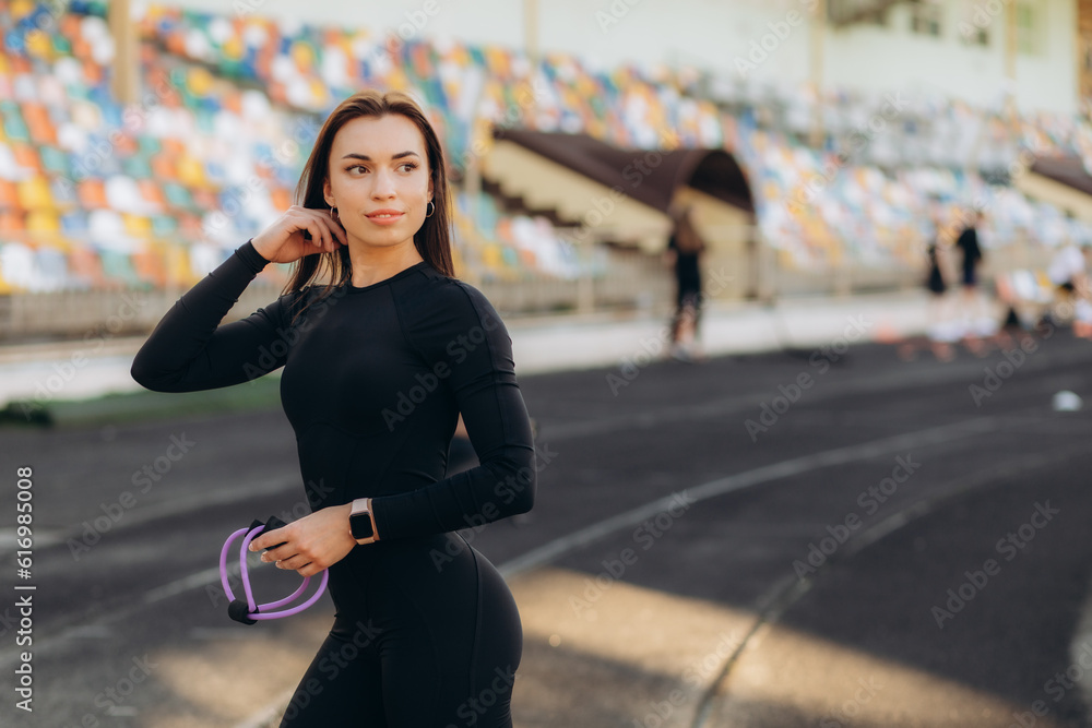 Woman Stretching And Warming-Up Arms Before Running. Fit sport woman stretching her body warm up standing on Running track start line ready jogging. Athletic woman prepare for running training