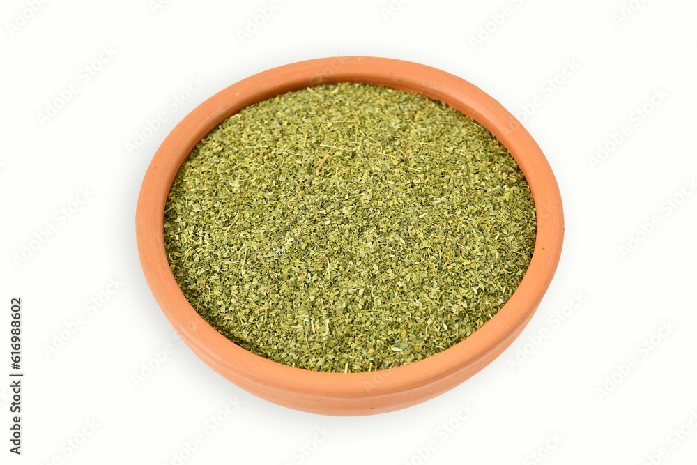 Organic dried moringa powder on clay pot, isolated on white background. copy space. top view. Heap of dehydrated moringa powder on white background, view from above.moringa granules. Organic dried moringa powder on clay pot, isolated on white background. copy space. top view. Heap of dehydrated moringa powder on white background, view from above.moringa granules.