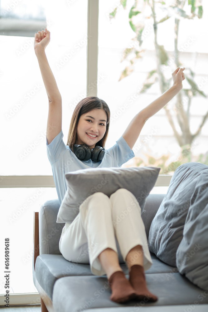 Beautiful Asian women feel relaxed on the weekends. She was sitting on a comfortable sofa at home. look at camera. Beautiful Asian women feel relaxed on the weekends. She was sitting on a comfortable sofa at home. look at camera.